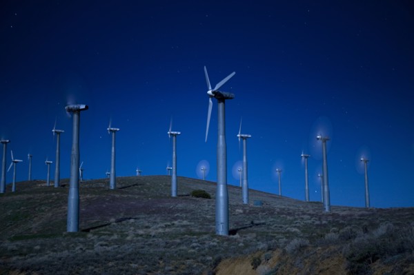 Wind turbines in landscape at night
