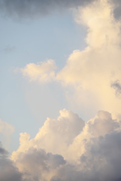 Soft white clouds against light sky
