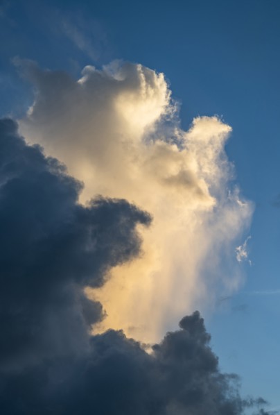 Dramatic cumulus cloud formations against blue sky