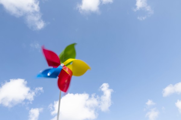 Colorful pinwheel blowing in wind against sky