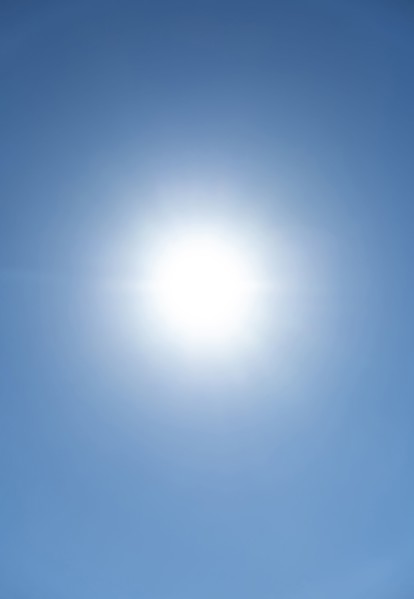 Bright sunburst in blue sky