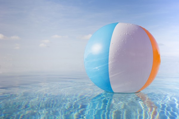 Beach ball floating on calm water surface