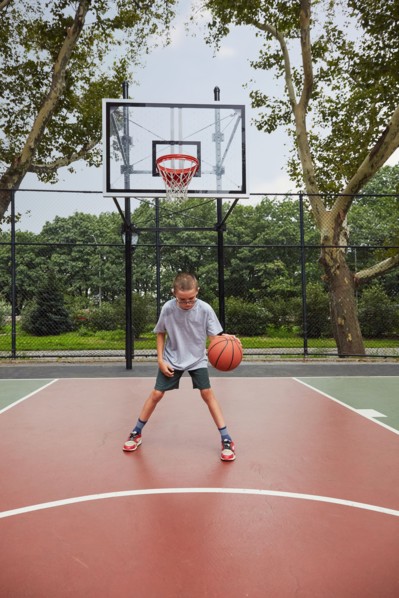 Boy playing basketball in park