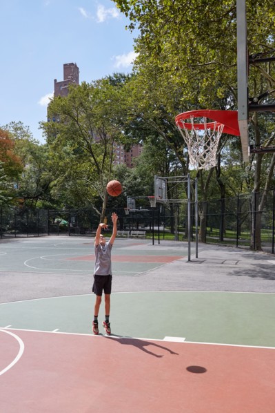 Boy playing basketball in park