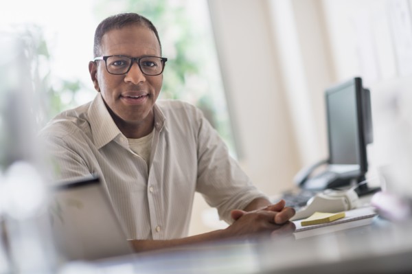 Portrait of smiling mature man working in home office