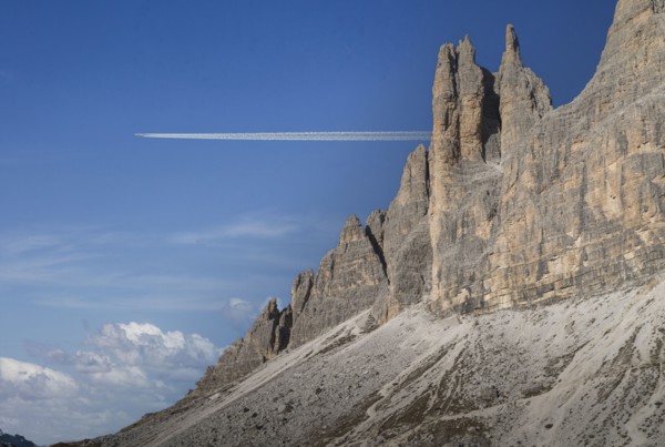 Commercial jet flying over Dolomites
