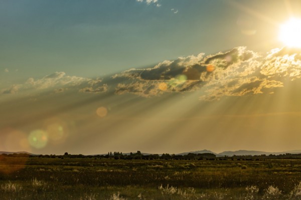 Late sun creating god rays over rural landscape