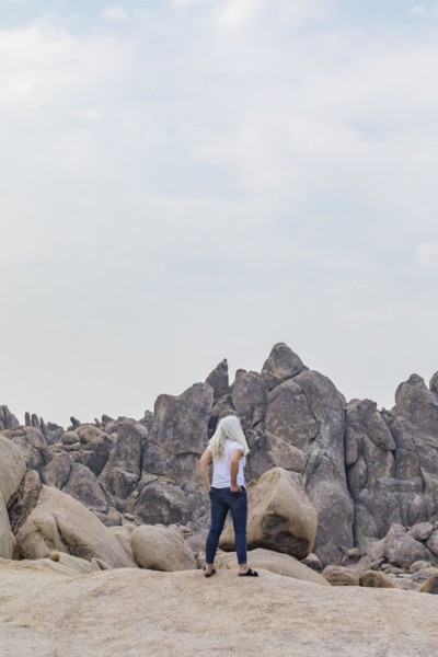 Woman looking at Alabama Hills rock formations