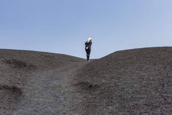 Woman hiking in cinder cone at Craters of the Moon National Monument