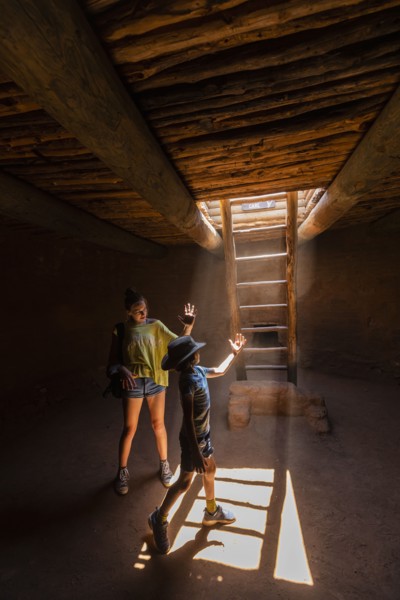 Boy and girl exploring Native American kiva