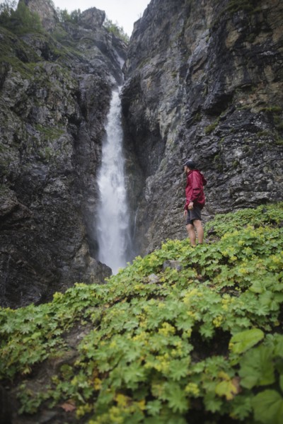 Hiker standing near waterfall