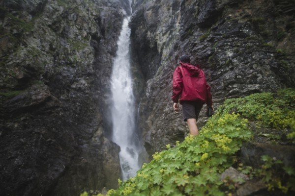Hiker standing near waterfall