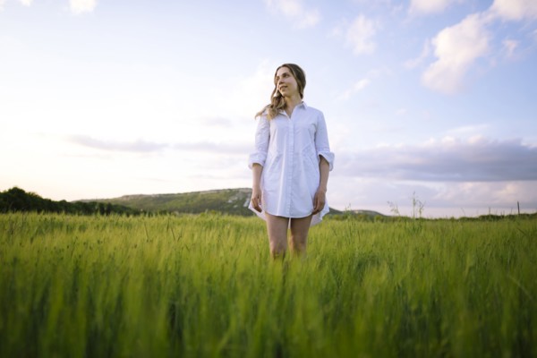 Young woman standing in agricultural field