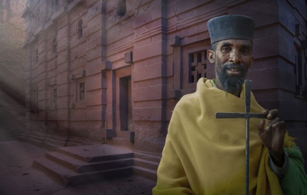 Black priest carrying cross in Lalibela