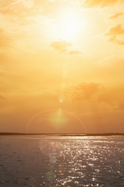 Sunset over rippling ocean water