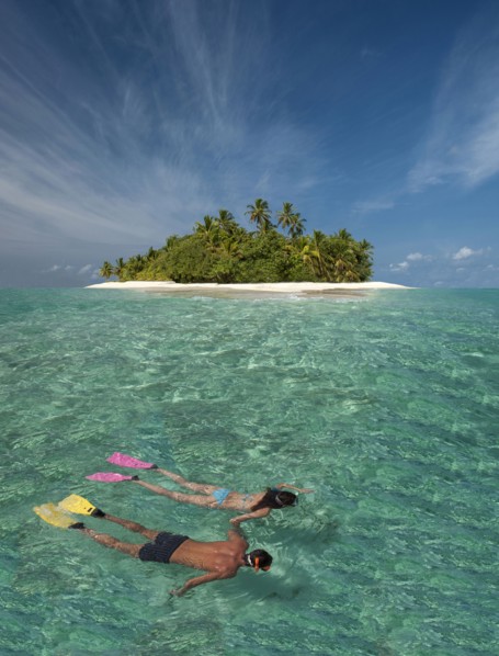 Caucasian couple snorkeling off tropical island
