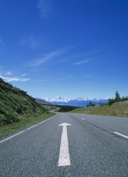 Directional arrow on empty remote road