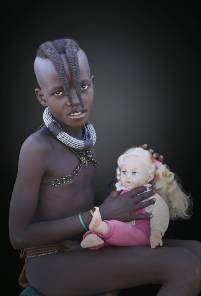Black girl playing with baby doll