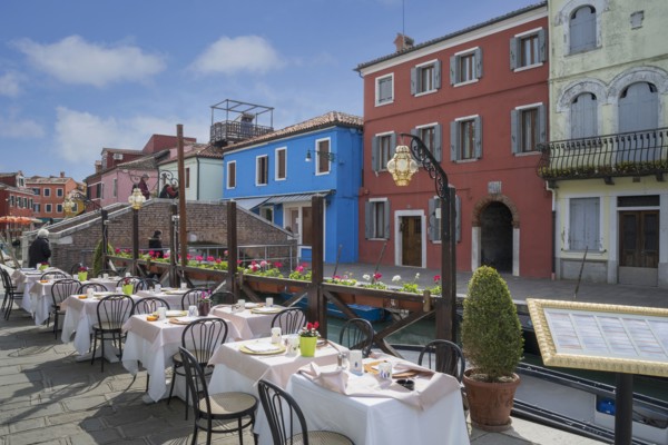Sidewalk cafe overlooking Venice Burano canal