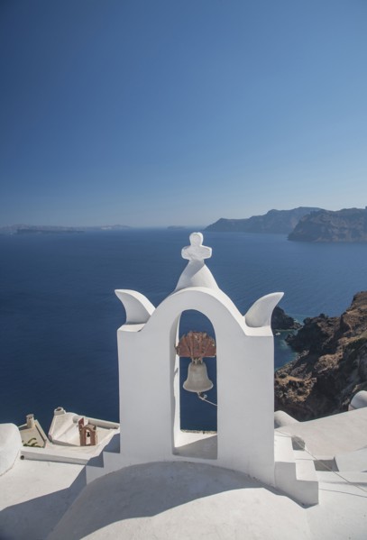 Church bell on hillside over seascape