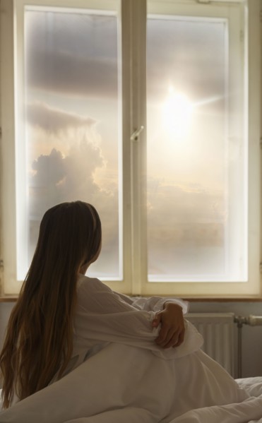 Caucasian woman looking out window