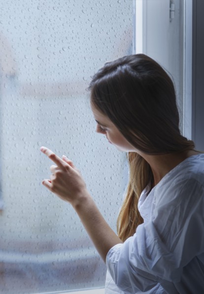 Caucasian woman looking out window