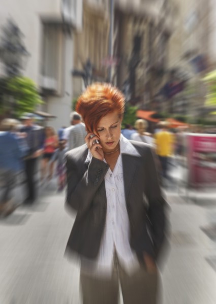 Caucasian businesswoman talking on cell phone in city