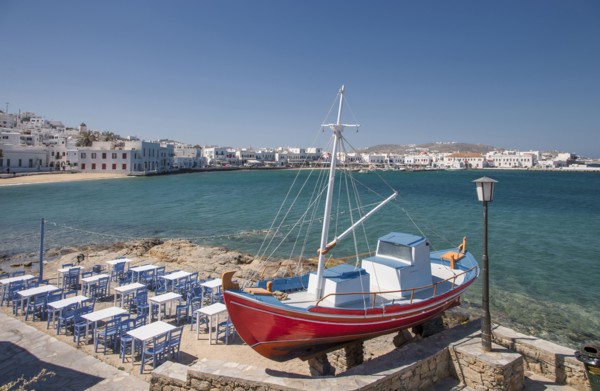 Boat and restaurant tables on oceanfront patio