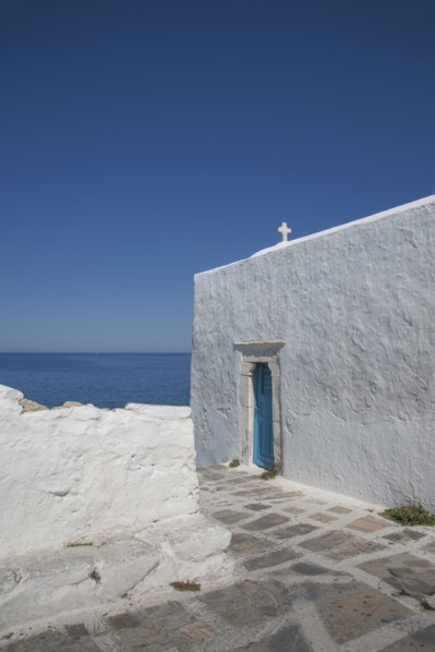 Cross on traditional building under blue sky