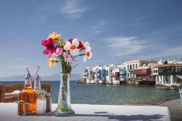 Seasonings and flowers on oceanfront cafe table