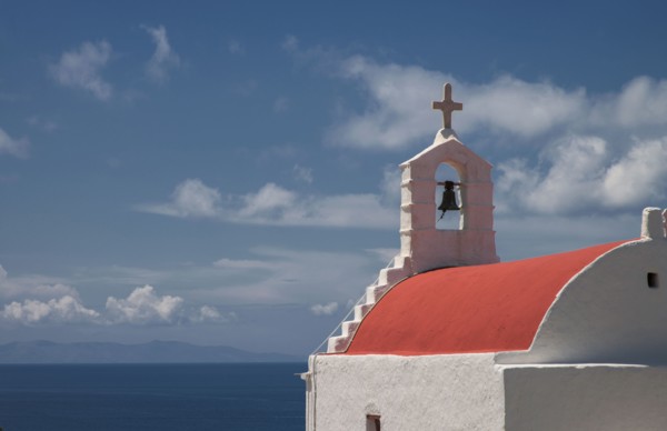 Traditional bell arch and seascape under blue sky