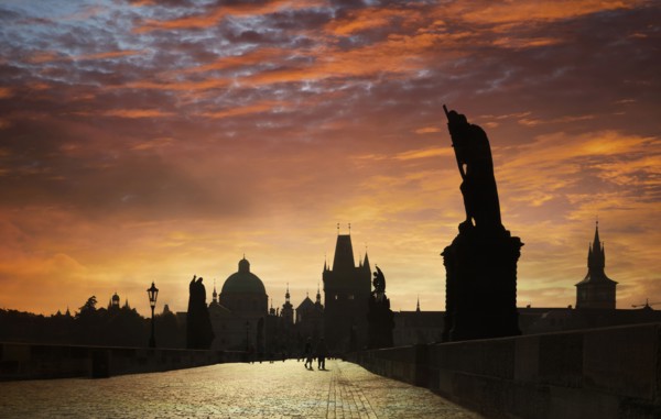 Silhouette of ornate buildings against sunset sky
