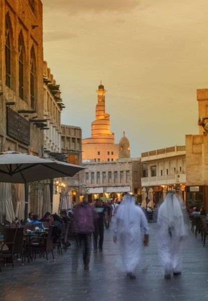 Blurred view of people walking on Doha street