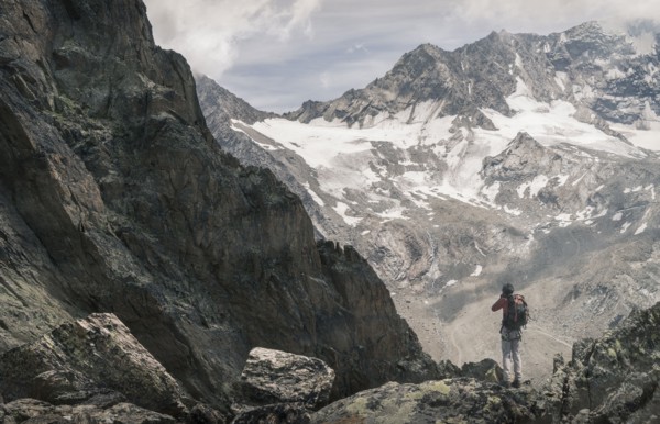 Caucasian man hiking on snowy mountain