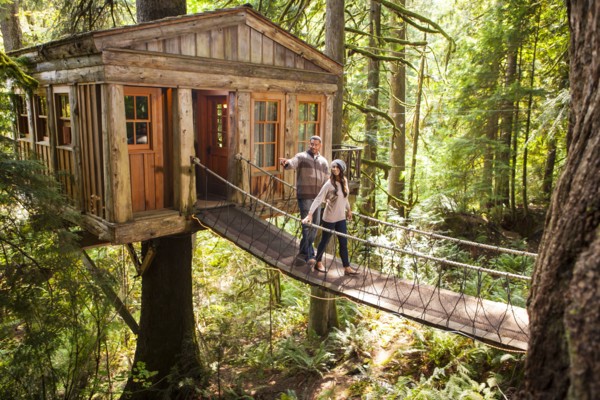 Couple on walkway of remote tree house