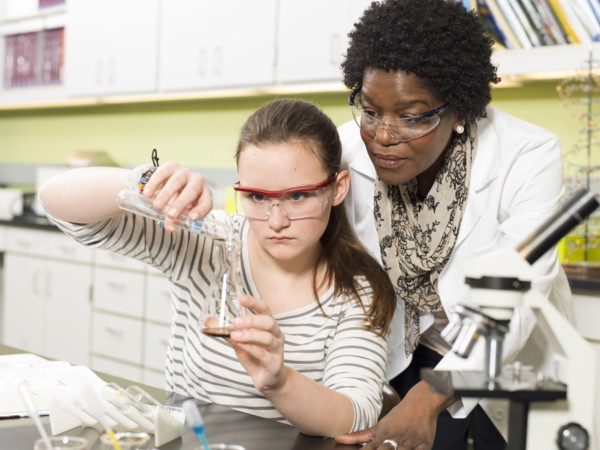 Student and teacher working in chemistry lab