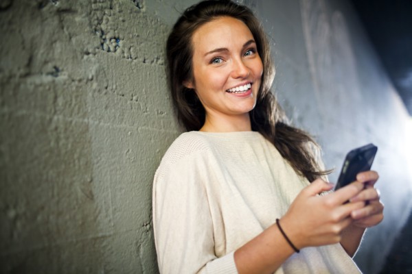 Caucasian woman using cell phone in tunnel