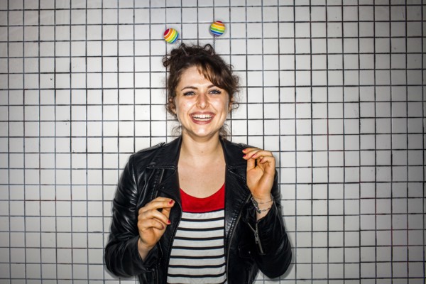 Caucasian woman wearing colorful antenna near wall