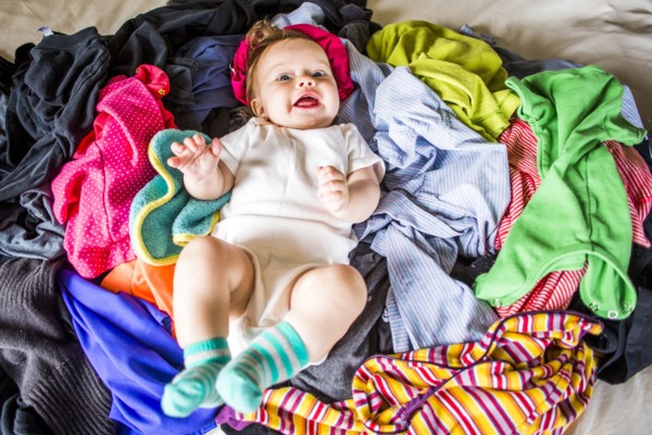 Caucasian baby girl laying in pile of laundry