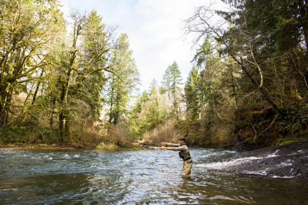 Caucasian fisherman fly-fishing in river