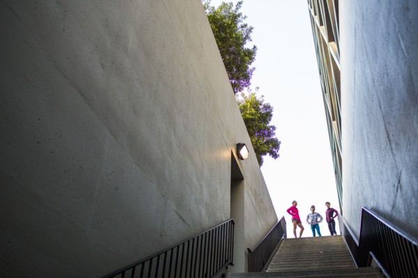 Runners standing at top of urban staircase