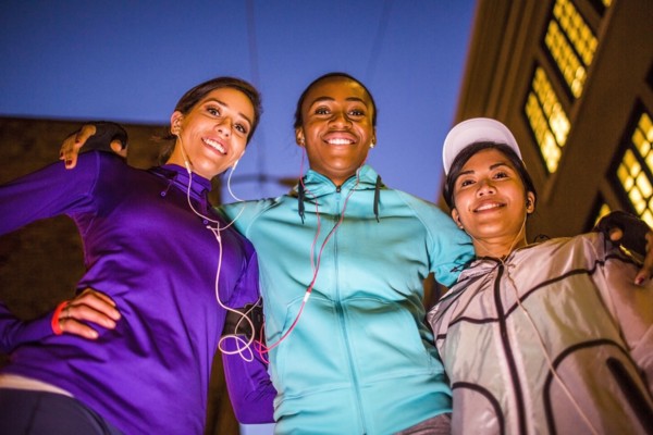 Low angle view of runners smiling at night