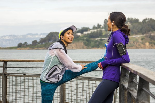 Runners stretching at waterfront