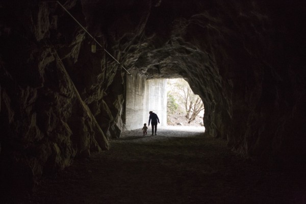 Caucasian mother and daughter walking in cave