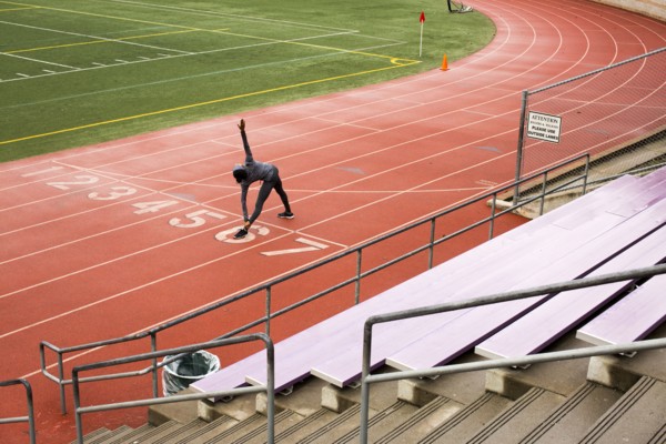 Black woman stretching on track