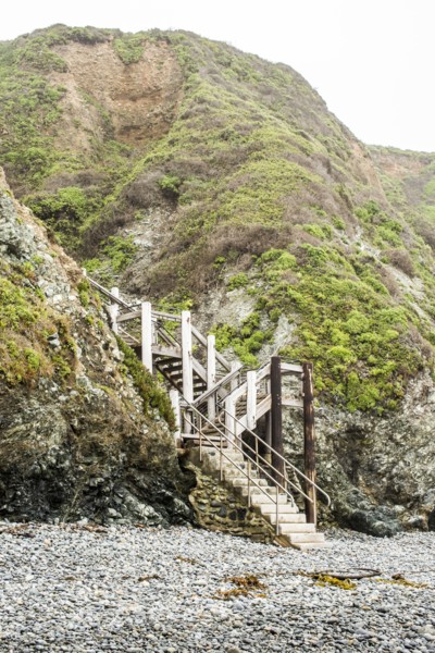 Staircase to hill on rocky beach