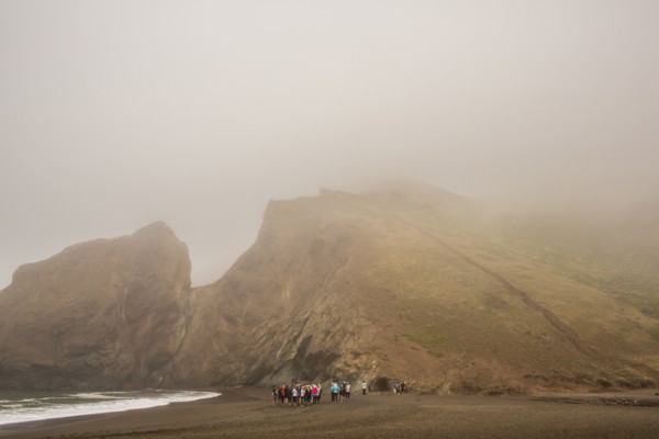 Distant crowd of people standing on beach