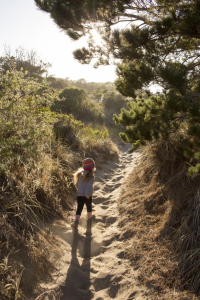 Caucasian girl walking on sandy path