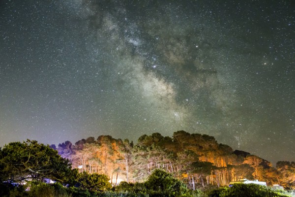 Starry night sky above mountains