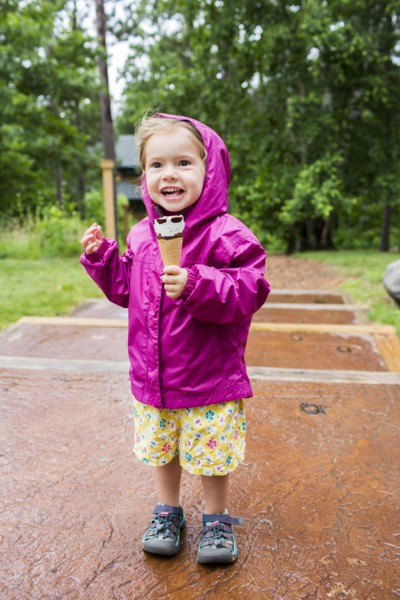 Smiling Caucasian girl eating ice cream cone